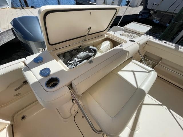 2017 Grady-White 300 Marlin boat with open storage compartment and seating.