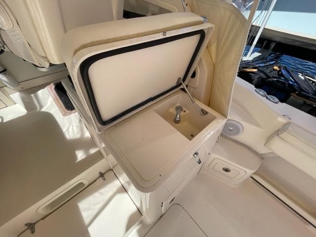 2017 Grady-White 300 Marlin boat interior with open storage compartment.