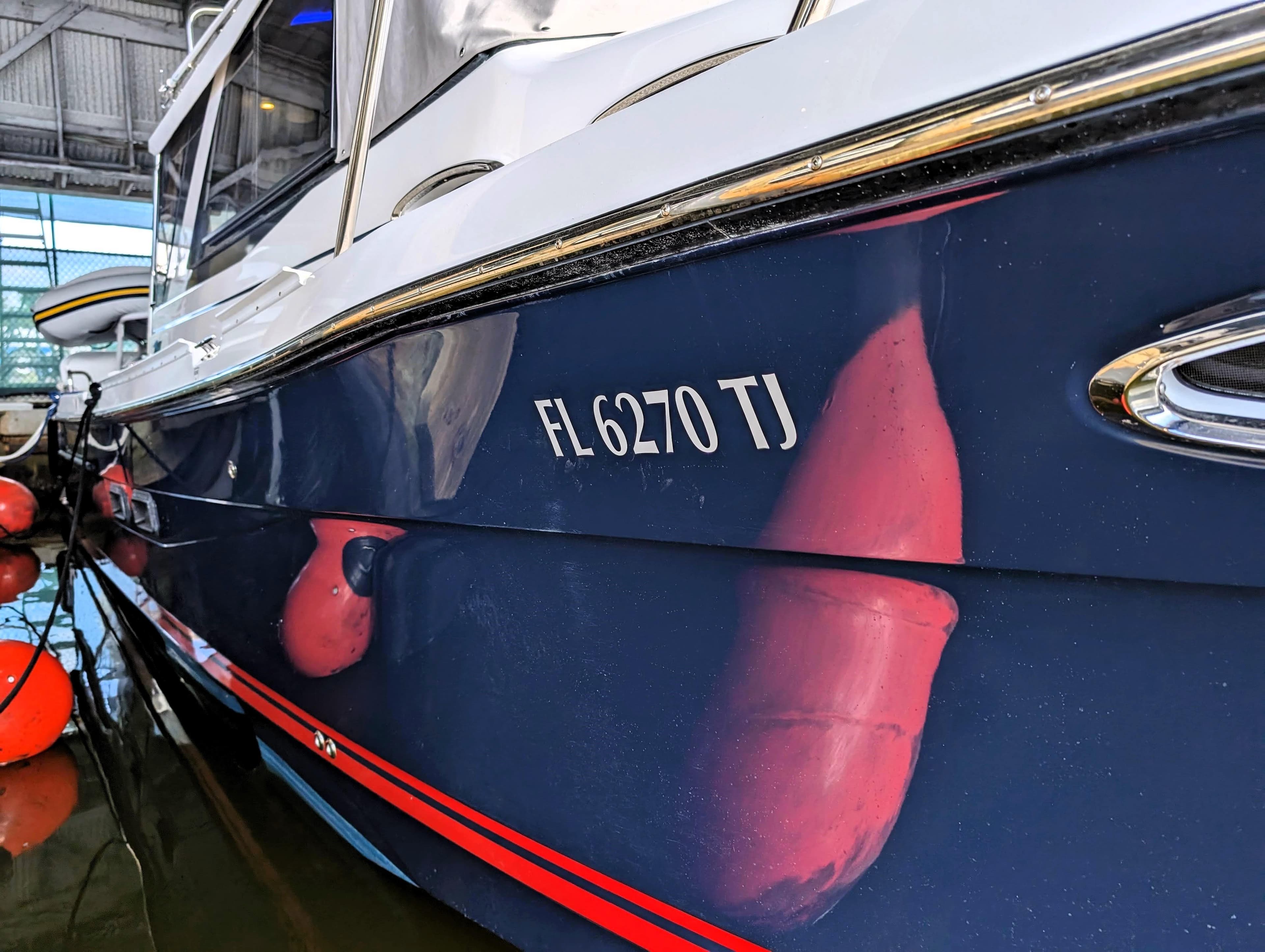 2022 Cutwater C-32 Coupe LE boat docked with registration number FL 6270 TJ.