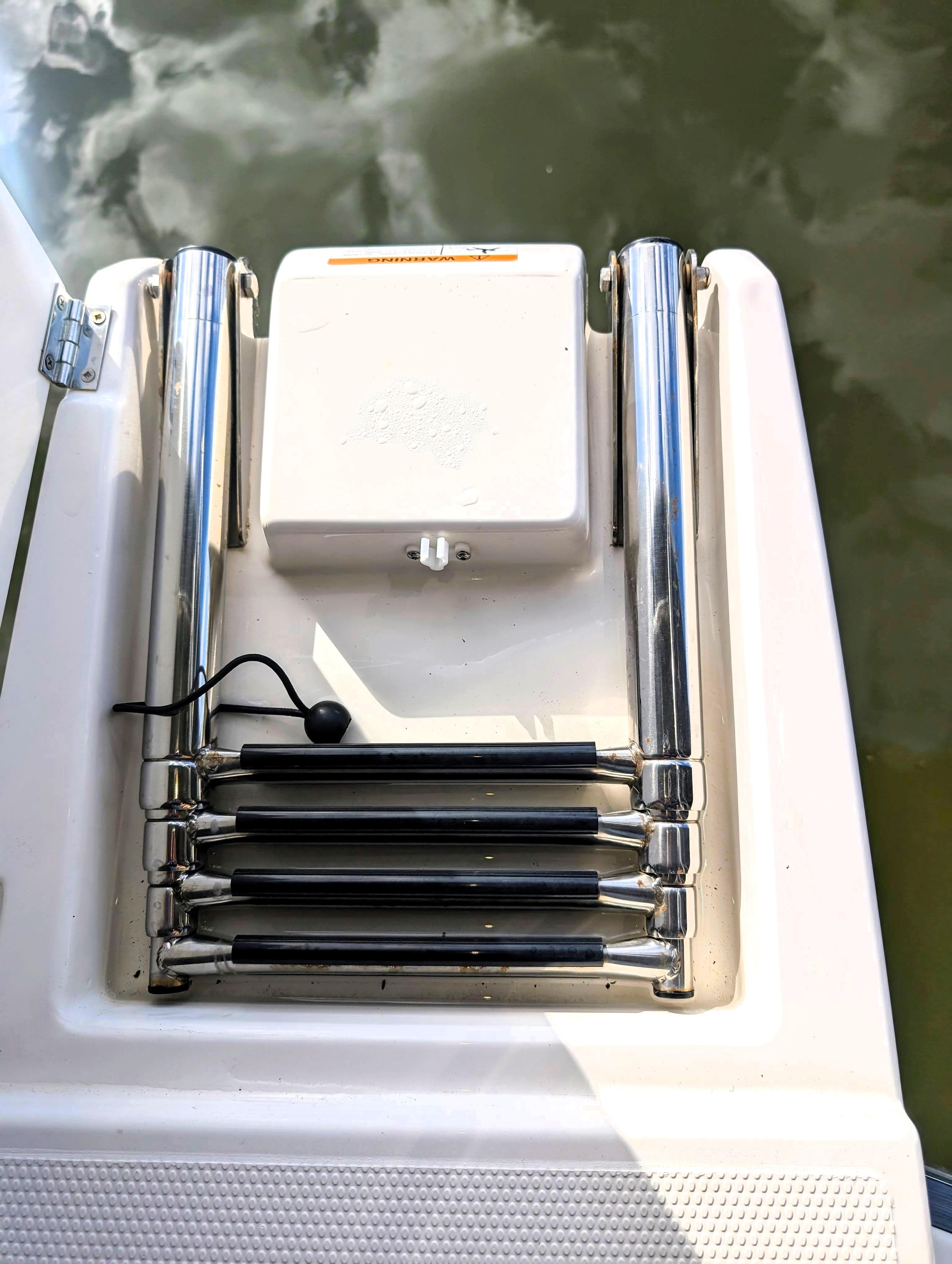 2022 Cutwater C-32 Coupe LE swim platform with retractable ladder.