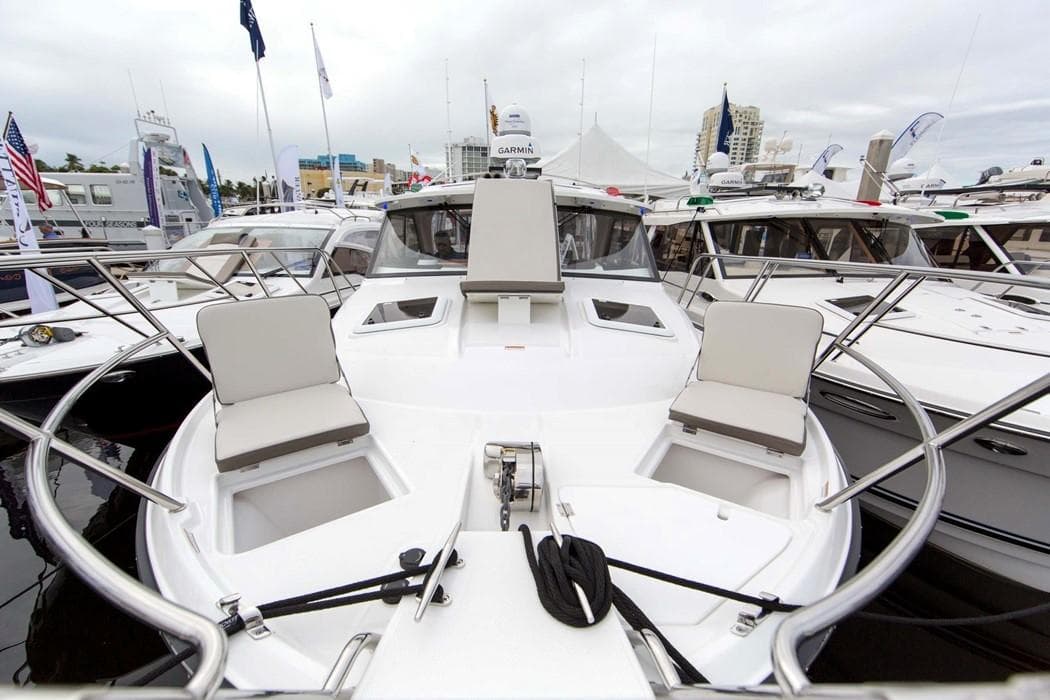 2022 Cutwater C-32 Coupe LE boat with spacious deck and seating at a marina.