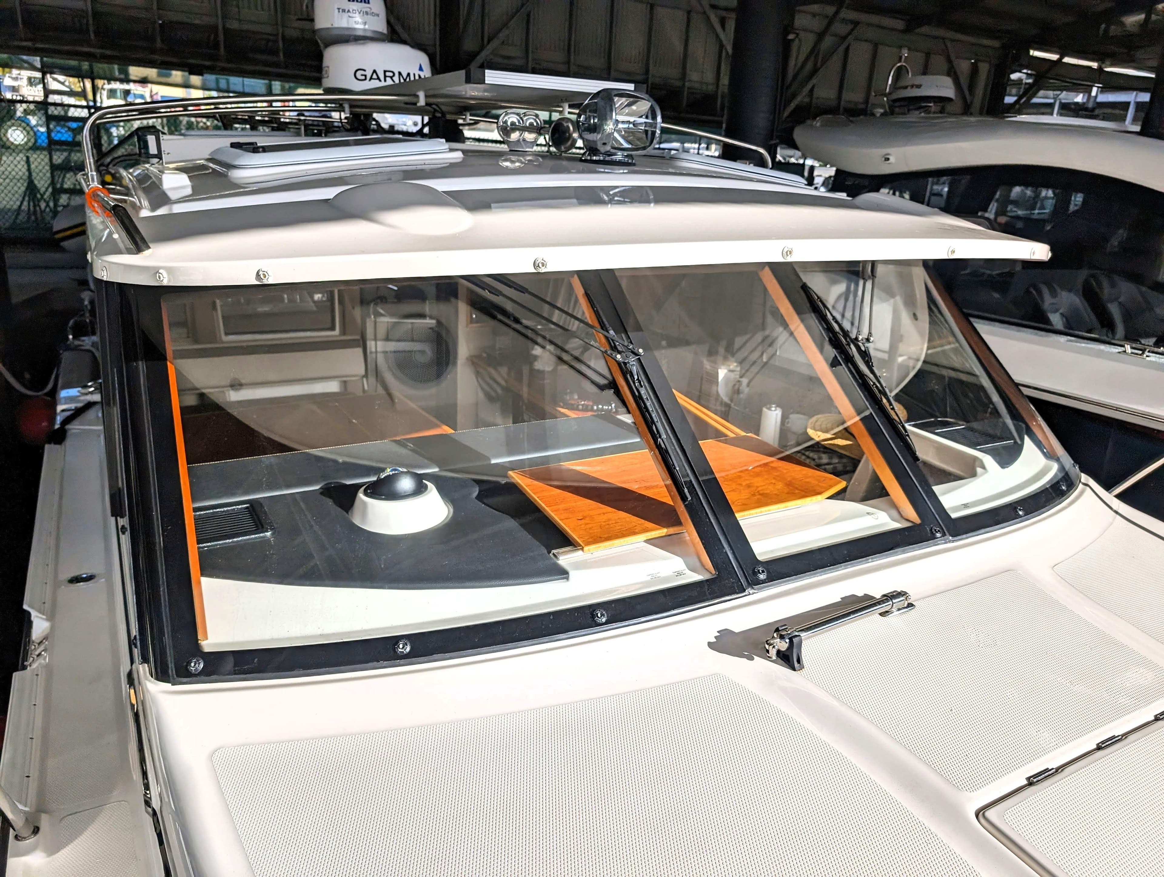 2022 Cutwater C-32 Coupe LE boat with Garmin equipment, docked in a marina.