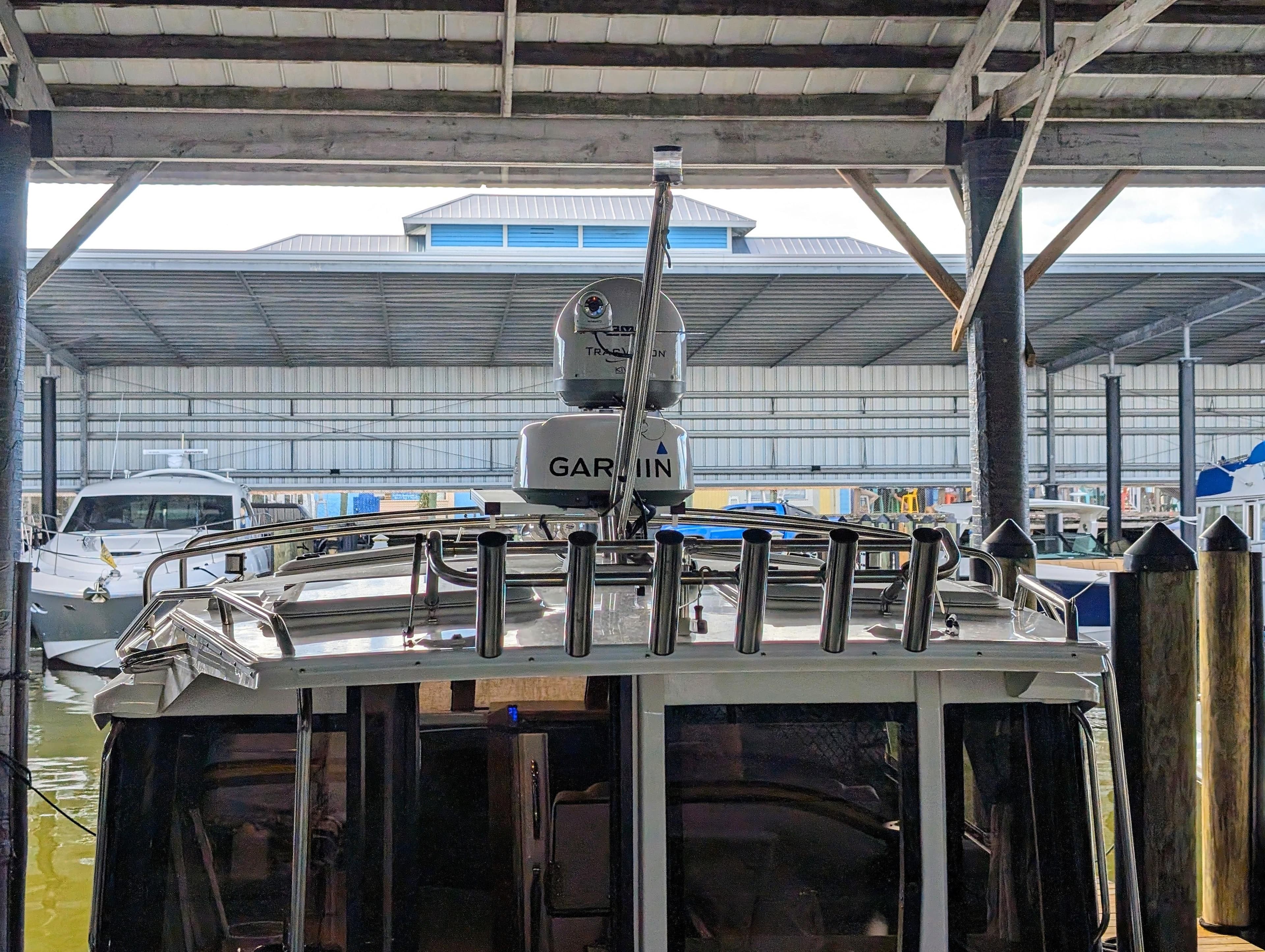 2022 Cutwater C-32 Coupe LE docked in a covered marina.