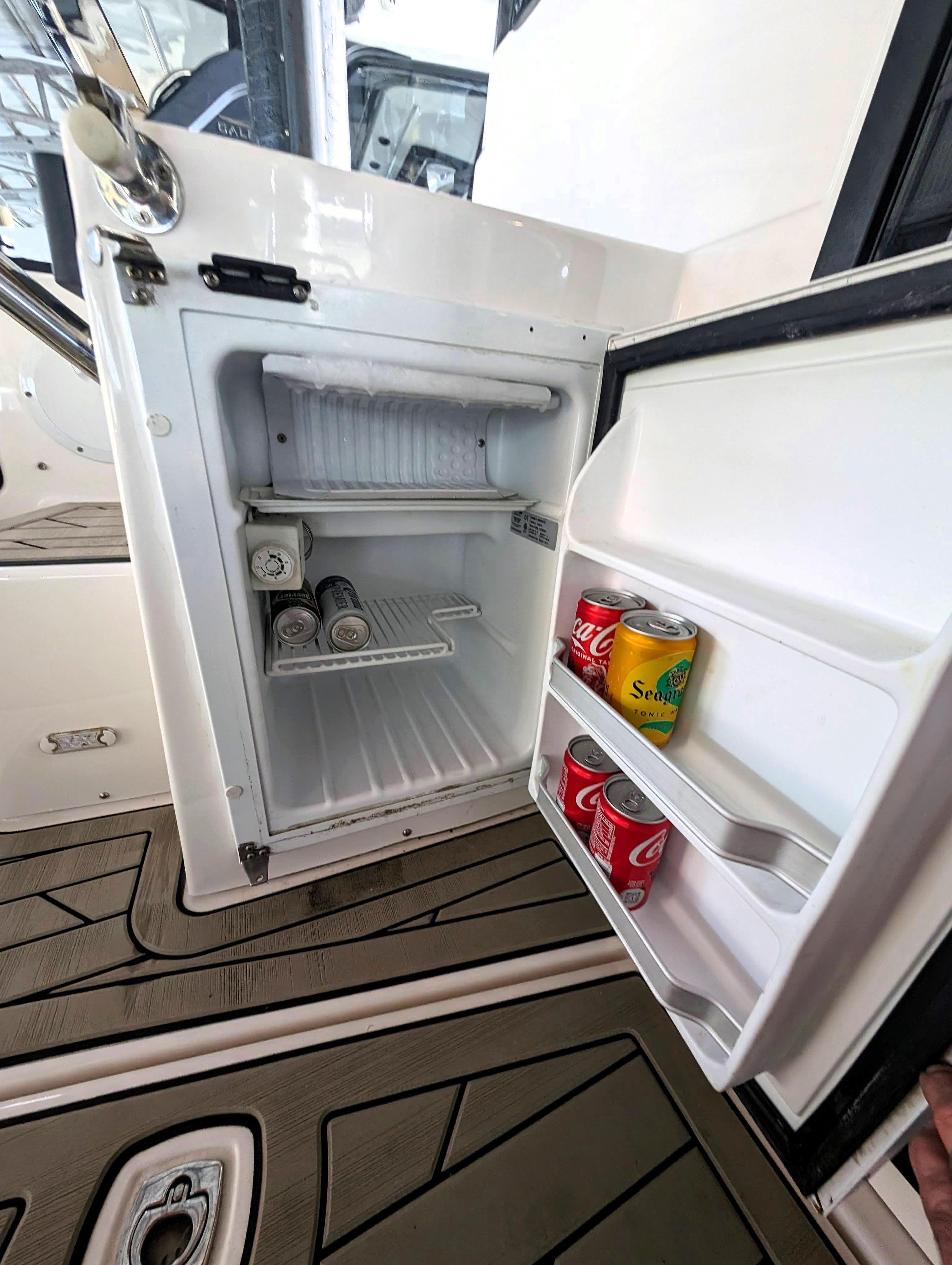 2022 Cutwater C-32 Coupe LE boat refrigerator with drinks inside.