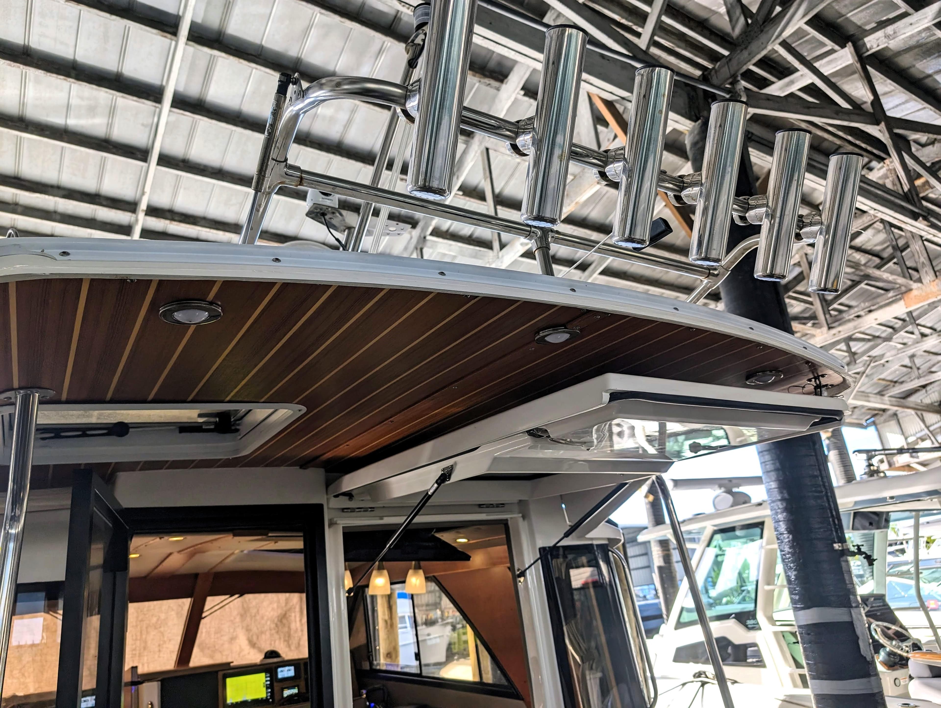 2022 Cutwater C-32 Coupe LE boat interior with rod holders and wooden ceiling.