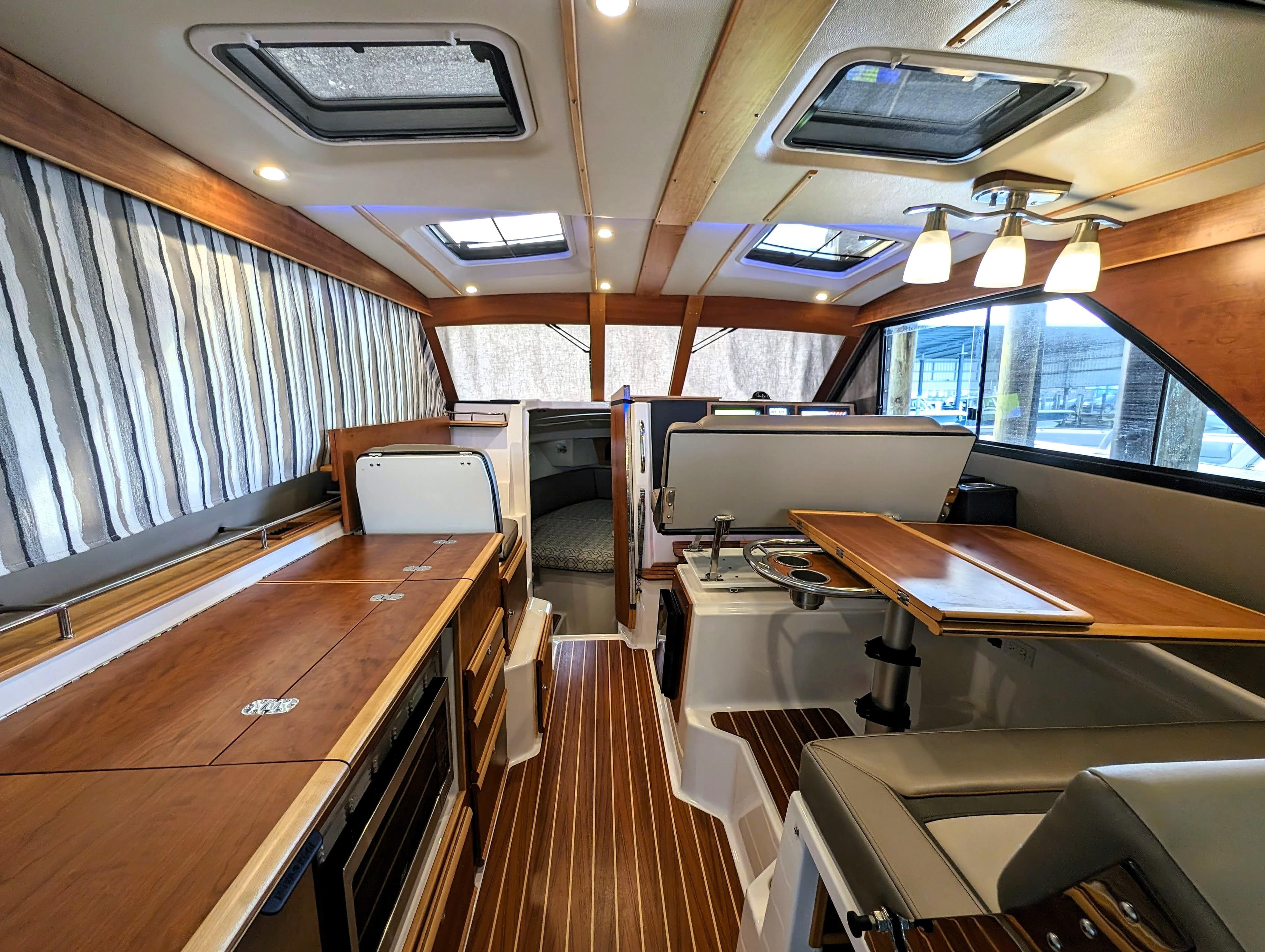 2022 Cutwater C-32 Coupe LE interior with modern kitchen and dining area.