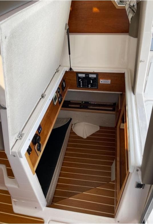 2022 Cutwater C-32 Coupe LE cabin interior with control panel and wooden flooring.