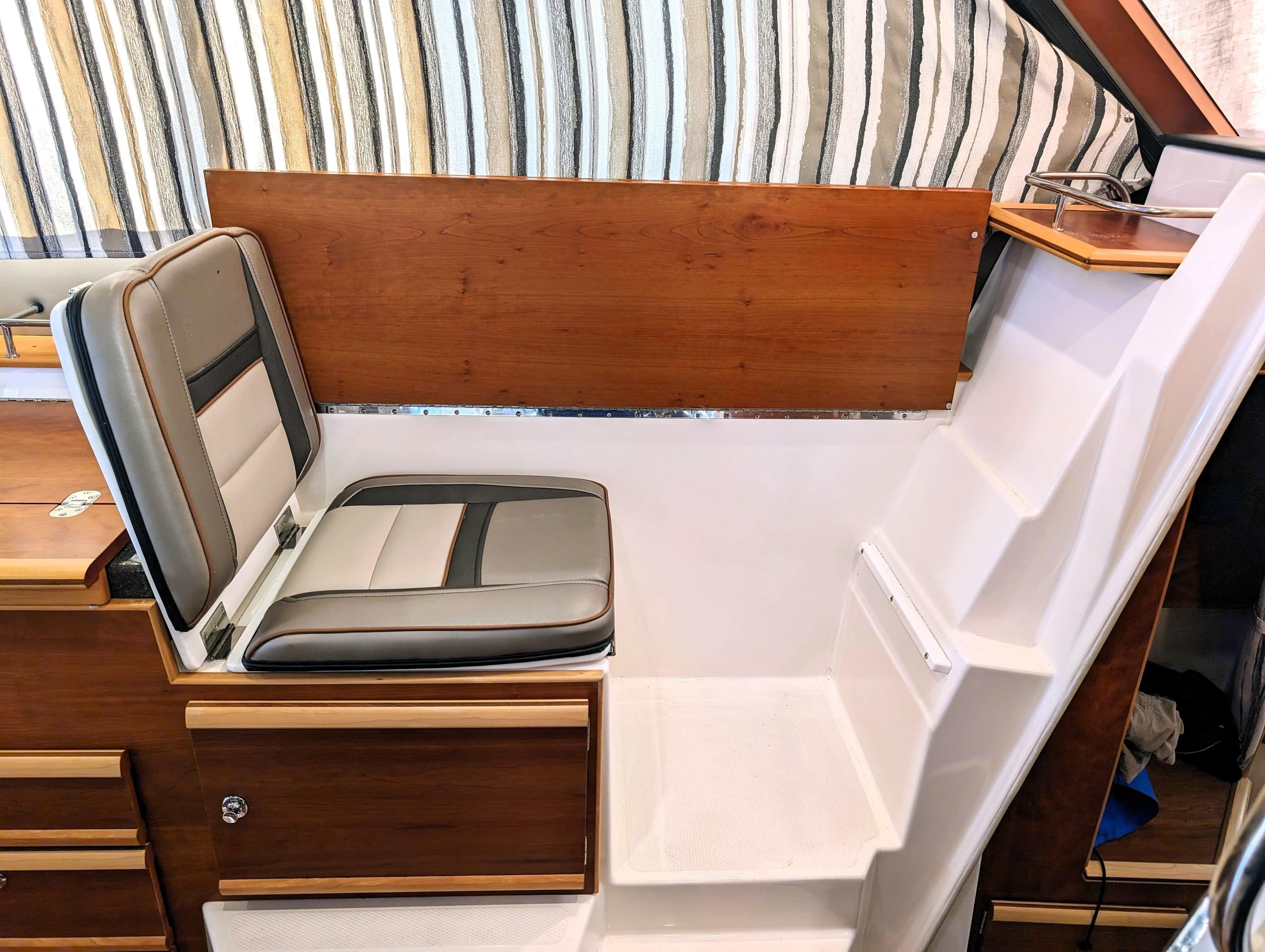 Interior seating and steps of 2022 Cutwater C-32 Coupe LE boat.